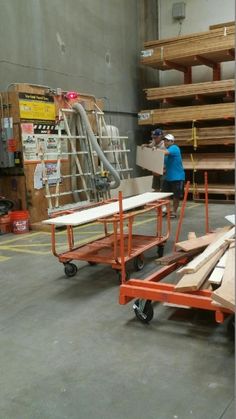 two men are working in a warehouse with pallets