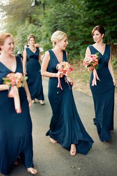 the bridesmaids are walking down the road together