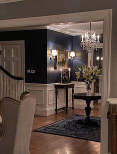 a living room filled with furniture and a chandelier