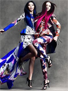 two women in colorful dresses posing for the camera