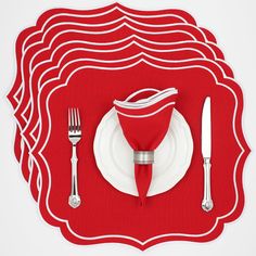 a place setting with red napkins and silverware