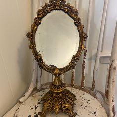 an antique mirror sitting on top of a white chair