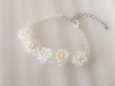 This bracelet is made of glass beads. Flowers are made of white beads layered on top of a flower motif made of clear beads. It is characterized by its cuteness and elegance. It can be used in a wide range of situations, from parties such as weddings to everyday use. Material: Glass pearls, glass beads, metal fittings (surgical stainless steel) Size: 15cm-21cm (6in-8in) Please note that the size is measured simply and there may be slight errors. The metal fittings used are less likely to cause metal allergies, however, we cannot guarantee that everyone will not have an allergic reaction. If you notice any abnormalities on your skin, discontinue use. White Beaded Flower-shaped Bracelet, White Flower-shaped Beaded Jewelry, Delicate White Flower-shaped Bracelet, White Flower-shaped Stretch Bracelet With Colorful Beads, Adjustable Flower-shaped Pearl Bracelet, White Beads, Glass Beads, Jewelry Bracelets, Bracelet