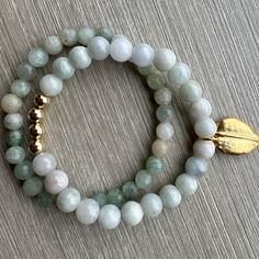 A beautifully beaded Aquamarine and Aventurine elastic bracelet stack with gold filled beads. The gold leaf charm is brass. The gold leaf can be removed and replaced with a metal stamped charm (see pictures for reference), or completly removed with no charm. Gold Beaded Bracelets With Natural Aventurine Stones, Gold Beaded Bracelets With Aventurine Stones, Gold Stretch Bracelet With Natural Stones For Meditation, Gold Aventurine Beaded Bracelets With Natural Stones, Gold Beaded Aventurine Bracelets With Natural Stones, Handmade Gold Aventurine Beaded Bracelets, Gold Beaded Bracelets With Amazonite Round Beads, Gold Aventurine Beaded Bracelets, Adjustable Gold Aventurine Beaded Bracelets