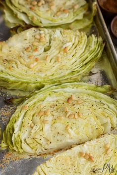 some artichokes are sitting on a baking sheet