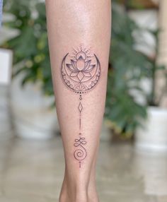 a woman's leg with a lotus tattoo on it