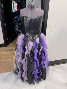 a dress made out of purple and black ruffles