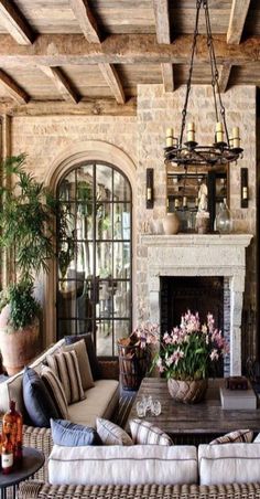 a living room filled with furniture and a fire place in front of a stone fireplace