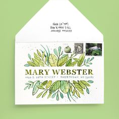 an envelope with the words mary webster written in green ink and leaves on it, against a light green background