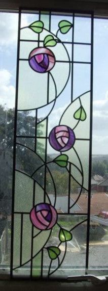 a stained glass window with flowers on it