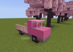 a pink truck is parked in front of some trees with purple boxes on it's back