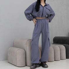 Women's tracksuit with trendy cargo pants featuring patch pockets. The pants have an adjustable drawstring at the bottom, allowing them to be worn as joggers. They feature a high-rise fit with an elastic waistband. The set includes a cropped zip-up jacket with adjustable drawstrings at the hem, enabling length customization. The jacket has a double-layered hood, patch pockets with flaps at chest level, and elastic cuffs. Material: Three-thread without fleece Colors: Black, white, khaki, and gray Winter Sportswear Tracksuit With Pockets, Winter Tracksuit With Pockets Sportswear, Sporty Gray Tracksuit With Pockets, Gray Tracksuit With Pockets For Loungewear, Solid Color Sporty Tracksuit With Pockets, Solid Color Athleisure Tracksuit With Pockets, Gray Loungewear Sets With Pockets, Sportswear Tracksuit With Pockets For Loungewear, Long Sleeve Tracksuit With Pockets For Streetwear