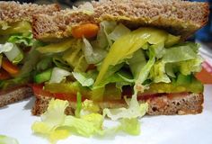 a sandwich with lettuce and tomatoes on it