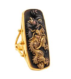 Exceptional Shakudo ring with Japanese Menuki. Fabulous and one of a kind Shakudo cocktail ring. This ring has been crafted in solid yellow gold of 14 karats with high polished finish, chiseled 24kt gold and blackened patinated bronze (niiro). The main decorative element displayed, is a genuine Japanese Menuki depicting the figure of a fierce dragon with the mythical pearl. The menuki mounted in this ring is an original part, recovered from a genuine antique Japanese sword from the Edo period (1603-1864). Created with exceptional Shakudo (mix of metals) technique, with blackened bronze and carefully chiseled with rich yellow gold of 24 karats. Weight: 16.7 grams, (10.71 Dwt). Measurements: 38 mm by 20 mm (1.50 x 0.79 Inches) and raise 10 mm over the finger. Size: 7.5 and may be sized on sp Ceremonial Gold Carved Signet Ring, Gold Carved Signet Ring For Ceremonial Use, Gold Carved Signet Ring For Ceremonial Occasions, Gold Ceremonial Carved Rings, Ceremonial Carved Gold Rings, Traditional Carved Yellow Gold Rings, Gold Ceremonial Rings With Carved Details, Gold Carved Rings For Ceremonial Occasions, Handmade Yellow Gold Rectangular Rings