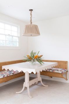 a white table and bench in a room