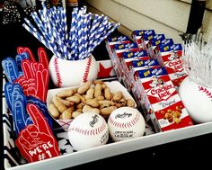 an assortment of baseball themed snacks and candy bar wrappers are displayed on a tray