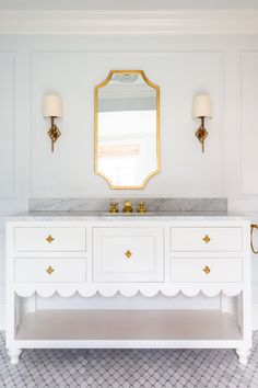 a white vanity with gold accents in a bathroom