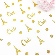 gold foiled confetti on white paper with pink flowers