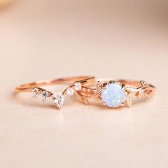 two gold rings with opal and diamond accents