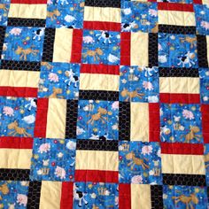 a blue and red quilt with animals on it