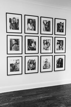 a black and white photo hanging on the wall in an empty room with wood flooring