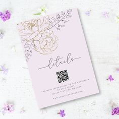 a pink wedding card with gold foil flowers and the word little written in cursive ink