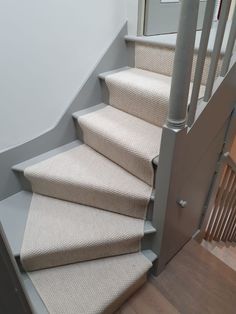 a set of stairs with beige carpet on them