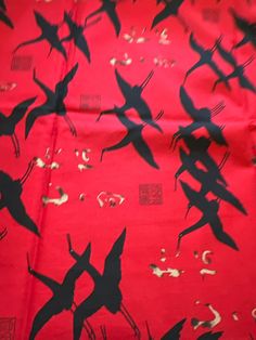 red and black fabric with birds on it