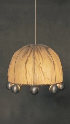 a lamp hanging from a ceiling with three balls on it