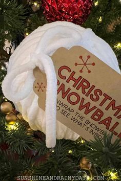 a christmas snowball ornament hanging on a tree