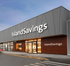 an island savings store is shown on the side of the street with cars parked outside