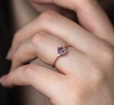 a woman's hand with a diamond ring on it