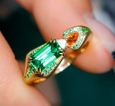 * Condition: Brand new * Center stone: Natural Sri Lanka Tsavorite, Asscher cut, approx 1.13ct * Side stones: Natural Spessartite Garnet, Pear Cut Natural White Diamond, Trillon-cut (VS1 clarity with F color) * Metal Purity: 18K Solid Yellow Gold (optional) * Free DHL Express Shipping. * Attached with Certificate. * Each piece is made-to-order with care and special attention to detail. all items are made with conflict-free diamonds and gems. * The item will be gift wrapped and shipped. --------- Luxury Tsavorite Ring With Gemstone Accents, Green Tsavorite Rings With Gemstone Accents, Unique Yellow Gold Emerald Ring With Accent Stones, Fine Jewelry Tsavorite Birthstone Ring, Tsavorite Rings With Gemstone Accents For Anniversary, Unique Green Sapphire Ring With Accent Stones, Fine Jewelry Tsavorite Rings For Gift, Tsavorite Gemstone Ring Fine Jewelry, Unique Green Tsavorite Ring