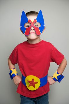 a young boy wearing a red shirt and blue mask