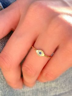 The eye is a doorway to light and life. It is a symbol of spirit, awakening, enlightenment, rebirth, and potential. This sweet, simple, and dainty evil eye-ring is perfect for a minimalist look, or for stacking. Style: Dainty Diamond and Blue Saphire Evil Eye Ring Metal: 14K Yellow Gold White Diamond Weight: 0.03 Carat Weight Blue Diamond Weight: 0.04 Carat Weight Ring Size: 6 Gold Sapphire Spiritual Promise Ring, Spiritual Gold Sapphire Promise Ring, Spiritual Evil Eye Rings As Gift, Spiritual Open Ring Birthstone, Spiritual Sapphire Promise Ring, Mystical Halo Rings As Gift, Spiritual Bezel Setting Promise Ring, Real Gold Hoop Earrings, Evil Eye Ring Gold