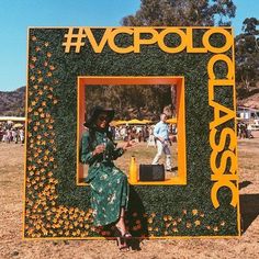 a woman sitting in front of a fake photo frame