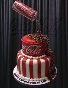 a coca - cola cake is decorated with chocolate shavings and candy canes