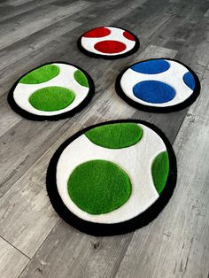 four rugs with different colors and shapes on the floor