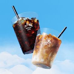 two iced drinks in plastic cups with straws on the top and ice below them