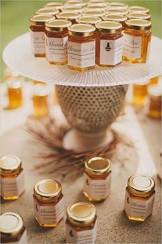 honey jars are arranged on a cake plate