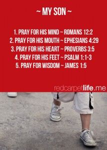 a person walking down a street holding a red sign that says, my son 1 pray for his mind - romans 12 22