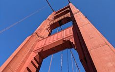 looking up at the golden gate bridge from below