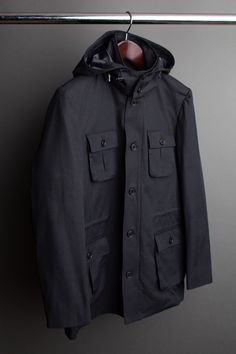 A handmade bespoke coat cut from a lightweight fully-waterproof cotton/poly fabric. This fabric is specifically engineered and guaranteed to keep you completely dry. If you don't have a go-to raincoat, this is the one. A good raincoat not only keeps you comfortable and protects your clothing - but it also makes you stand apart from the crowd with smart, understated style. Cotton Outerwear With Pockets For Rainy Weather, Cotton Outerwear For Rainy Weather, Cotton Parka With Detachable Hood, Cotton Raincoat With Pockets For Rainy Weather, Hooded Cotton Raincoat For Rainy Weather, Winter Cotton Raincoat For Rainy Weather, Waterproof Hooded Cotton Outerwear, Hooded Waterproof Cotton Outerwear, Waterproof Cotton Outerwear