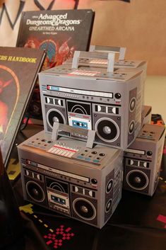 an old fashioned boombox is sitting on a table with other items in front of it