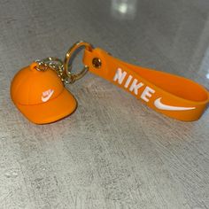 This Stylish Nike Keychain Features A Cap Design In A Vibrant Gold And Orange Color Combination, Perfect For Accessory Lovers Looking To Add A Pop Of Color To Their Collection. All Rubber And Gold Plated Metal- Super Easy To Clean All Keychains Are New Without Tags!!!! Offers Welcome! Pet Free Smoke Free Home Nike Keychain, Orange Color Combinations, Gold And Orange, Nike Gold, Devin Booker, Nike Accessories, Gold Orange, Cap Design, Key Card Holder