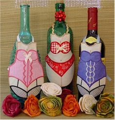 three wine bottles decorated with different designs and colors