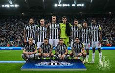 a group of soccer players pose for a team photo