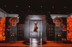 an indoor basketball themed party with orange balloons