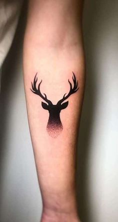 a black and red deer head tattoo on the left arm, with an ombretta