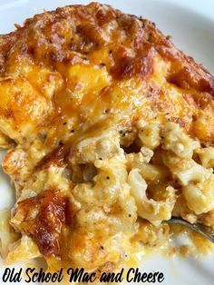 an old school mac and cheese casserole on a white plate with a fork